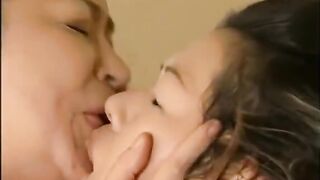 Asian: Older and younger woman share a kiss #2