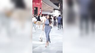 Busty beauty walking in the street